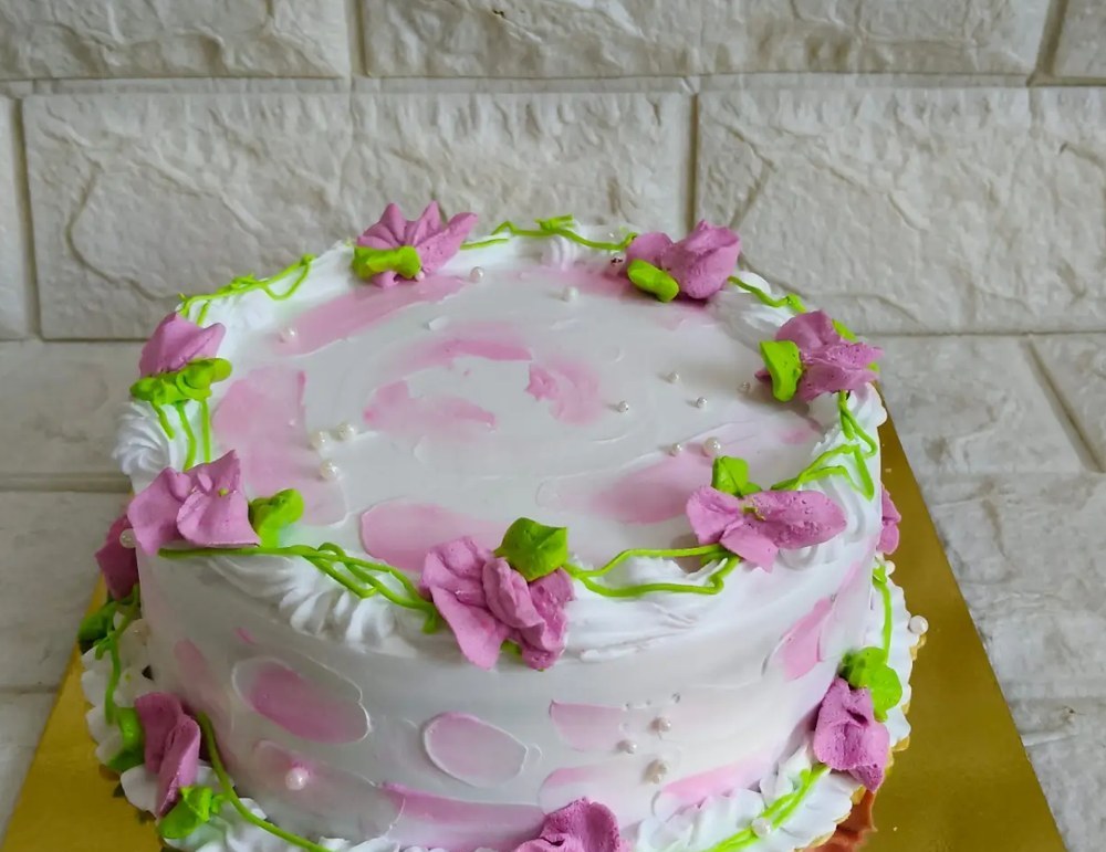 Pink watercolour cake with piped flowers